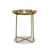 A round brass side table with a tray top and crossed metal legs, perfect for adding elegance to your space. Ideal for Gold Coast wedding hire, this piece seamlessly blends style and functionality.