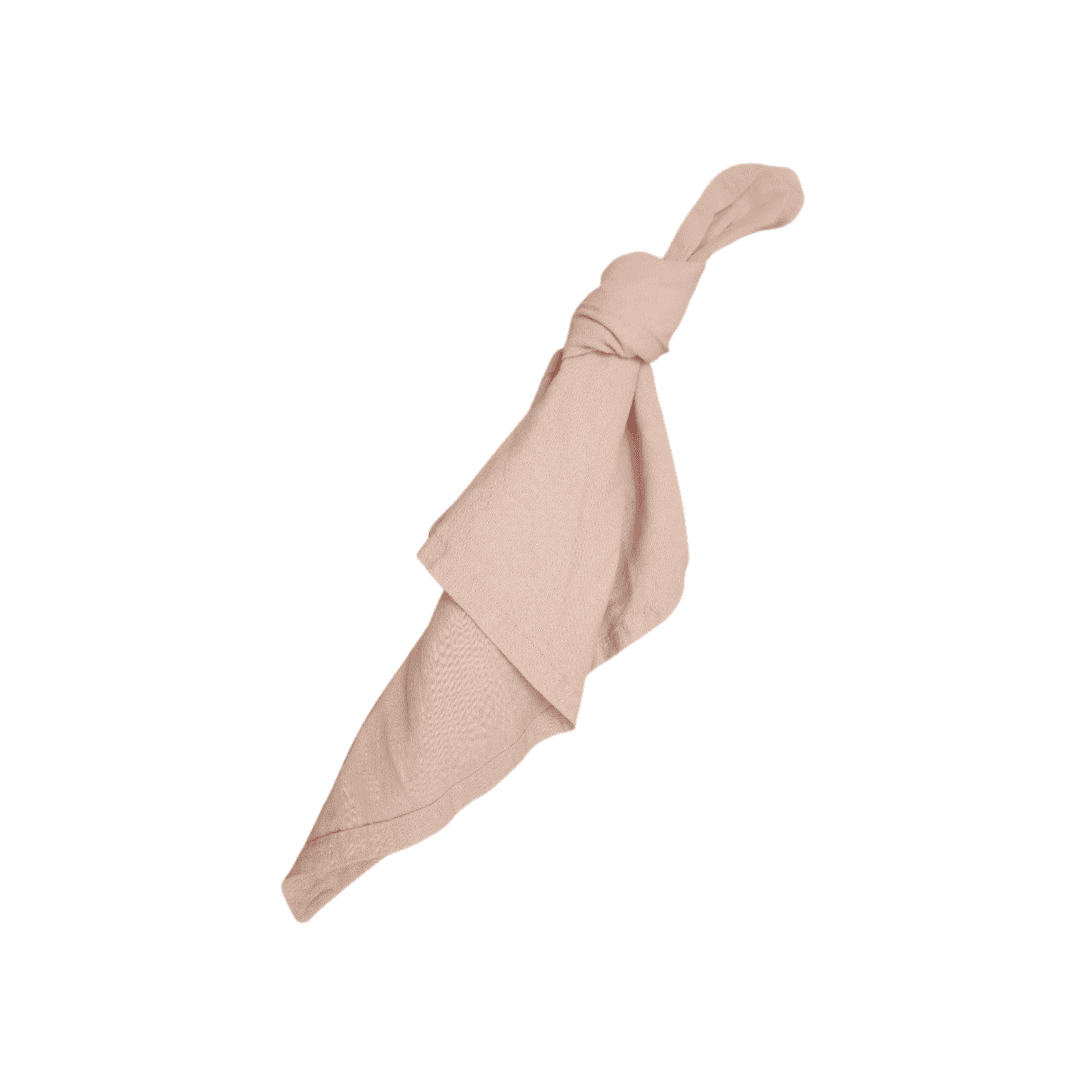 The Napkin | Blush Linen, shown tied in a loose knot on a white background, is ideal for picnic hire Gold Coast or adding elegance to any wedding ceremony hire Sunshine Coast.