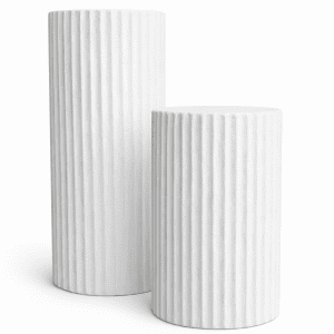 Two white, cylindrical Pedestal l White Round display stands with vertical ridges are side by side on a plain white background; the taller stand sits next to its shorter counterpart.