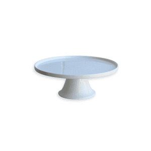 The Cake Stand is a plain white ceramic piece featuring a round flat top and a wide, sturdy base, displayed against a white background.